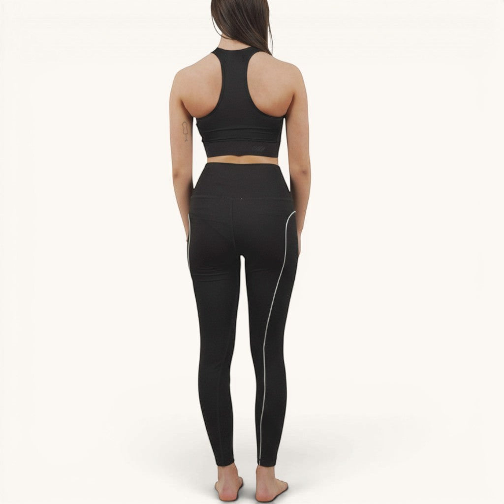 Numero 5 black polyamide and elastane leggings with white side stripe detail. Women's activewear.