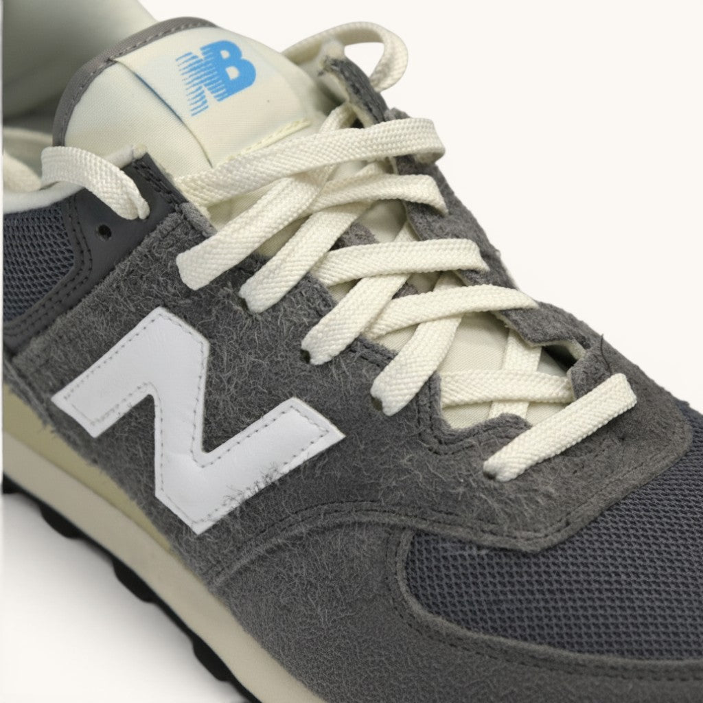 Numero 5 New Balance grey suede and mesh sneakers with white laces and iconic N logo.