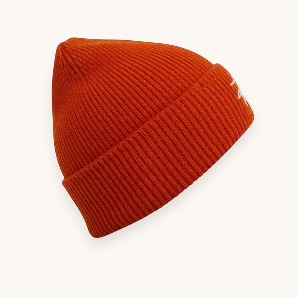 Numero 5 orange ribbed beanie with white Stussy logo embroidery. Acrylic, nylon, and PBT blend.