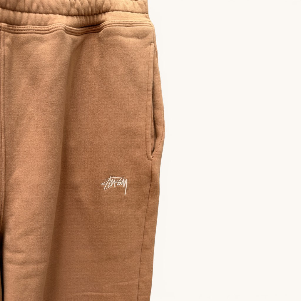 Numero 5 Stussy beige cotton sweatpants with embroidered logo detail and side pockets.
