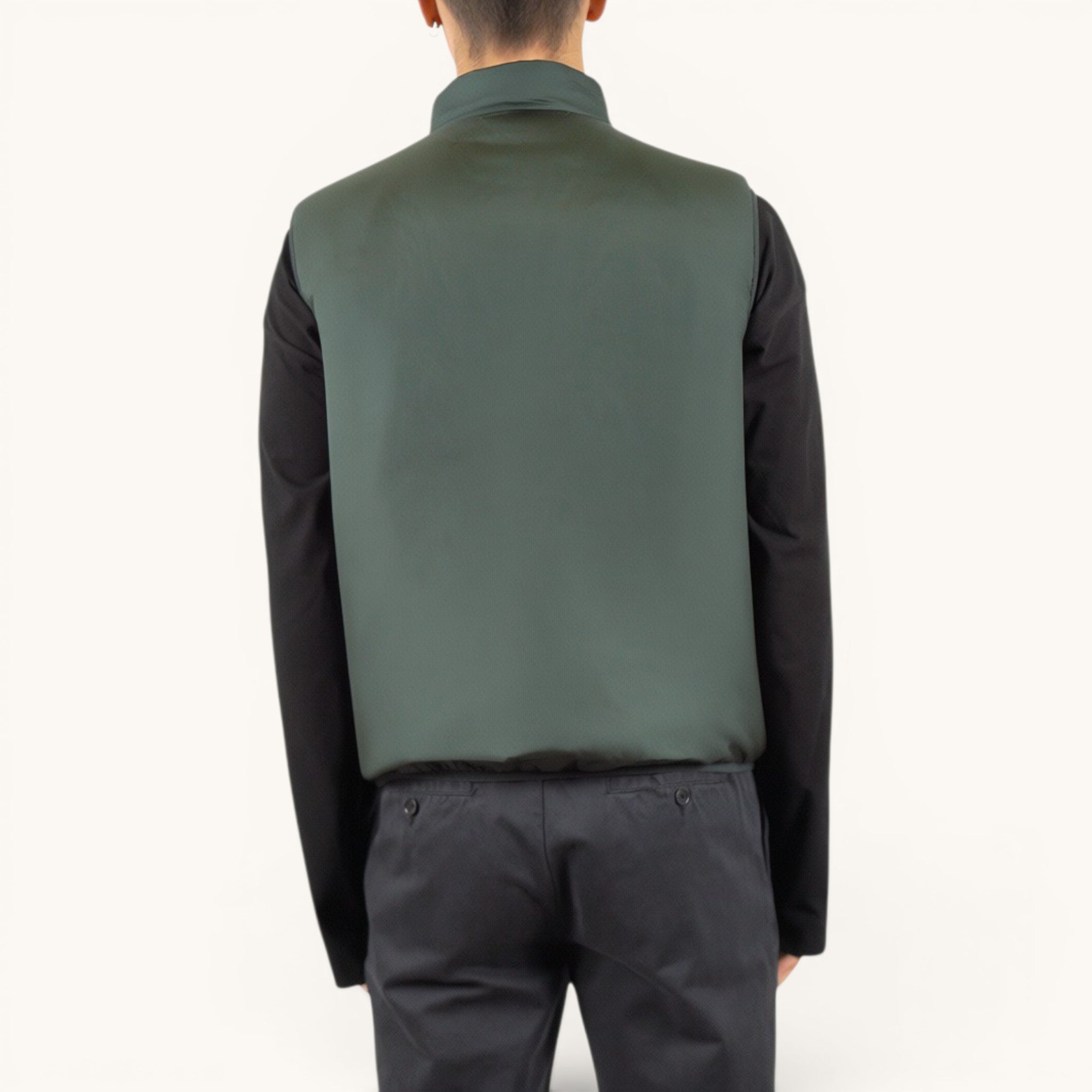 Numero 5 Aspesi green quilted vest with a high collar, worn over a black long-sleeved shirt.