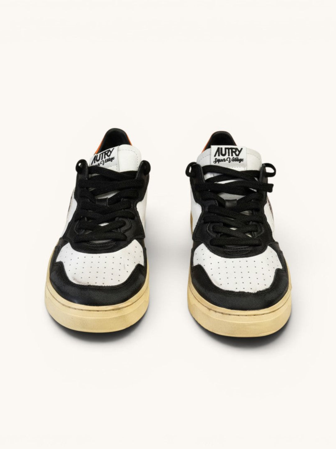 Numero 5 Autry white, black, and orange leather sneakers with perforated toe box and lace-up closure.