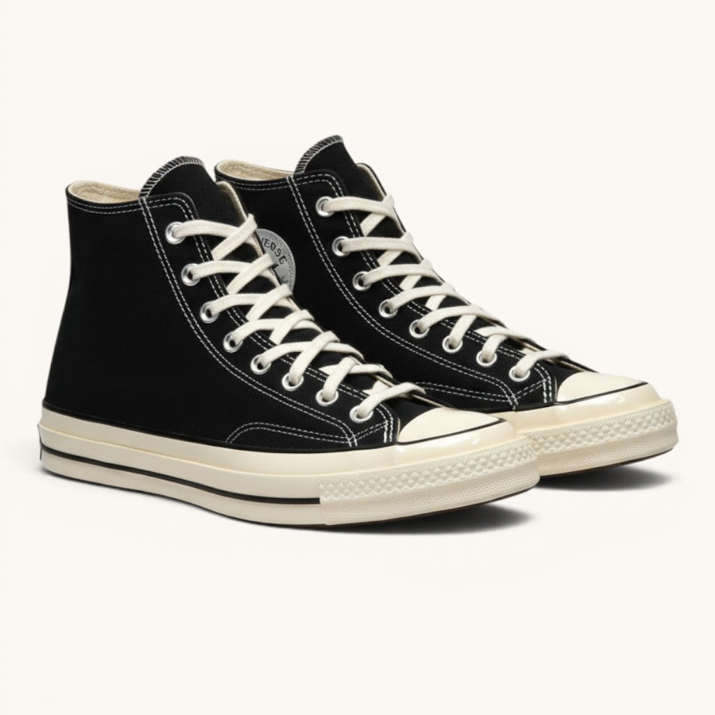 Numero 5 Converse black high-top canvas sneakers with white laces and rubber toe cap.