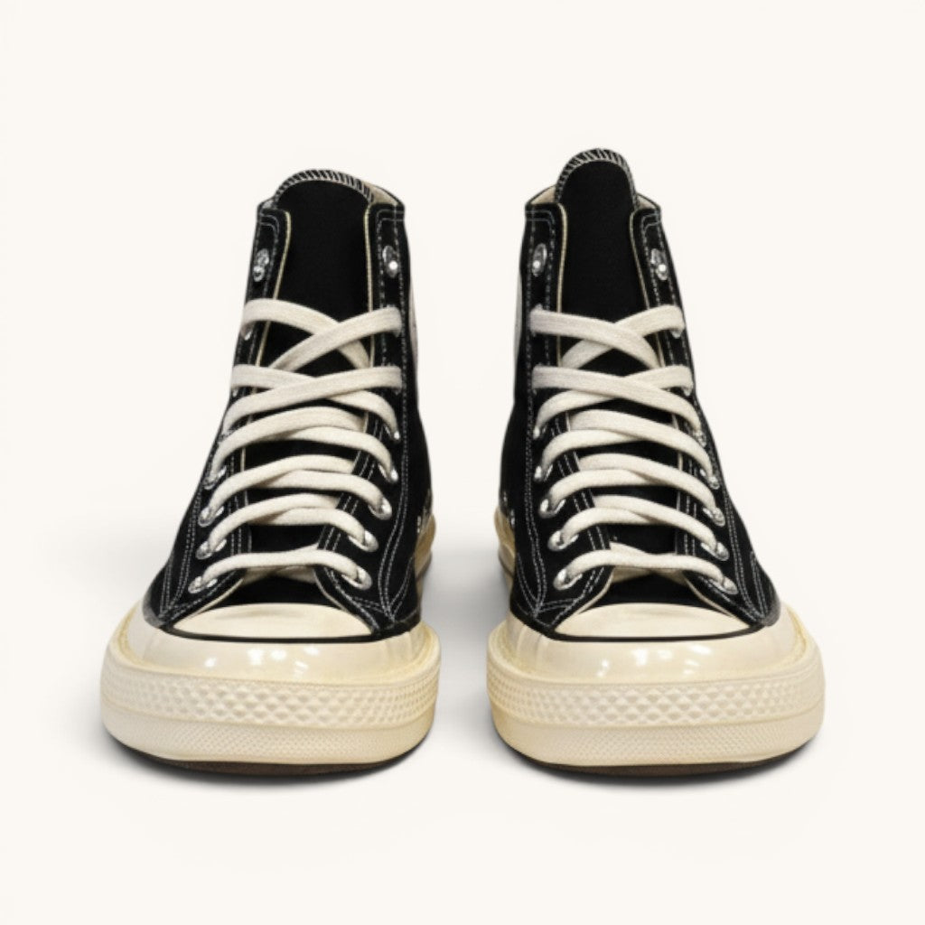 Numero 5 black canvas high-top Converse sneakers with white laces and off-white rubber sole.