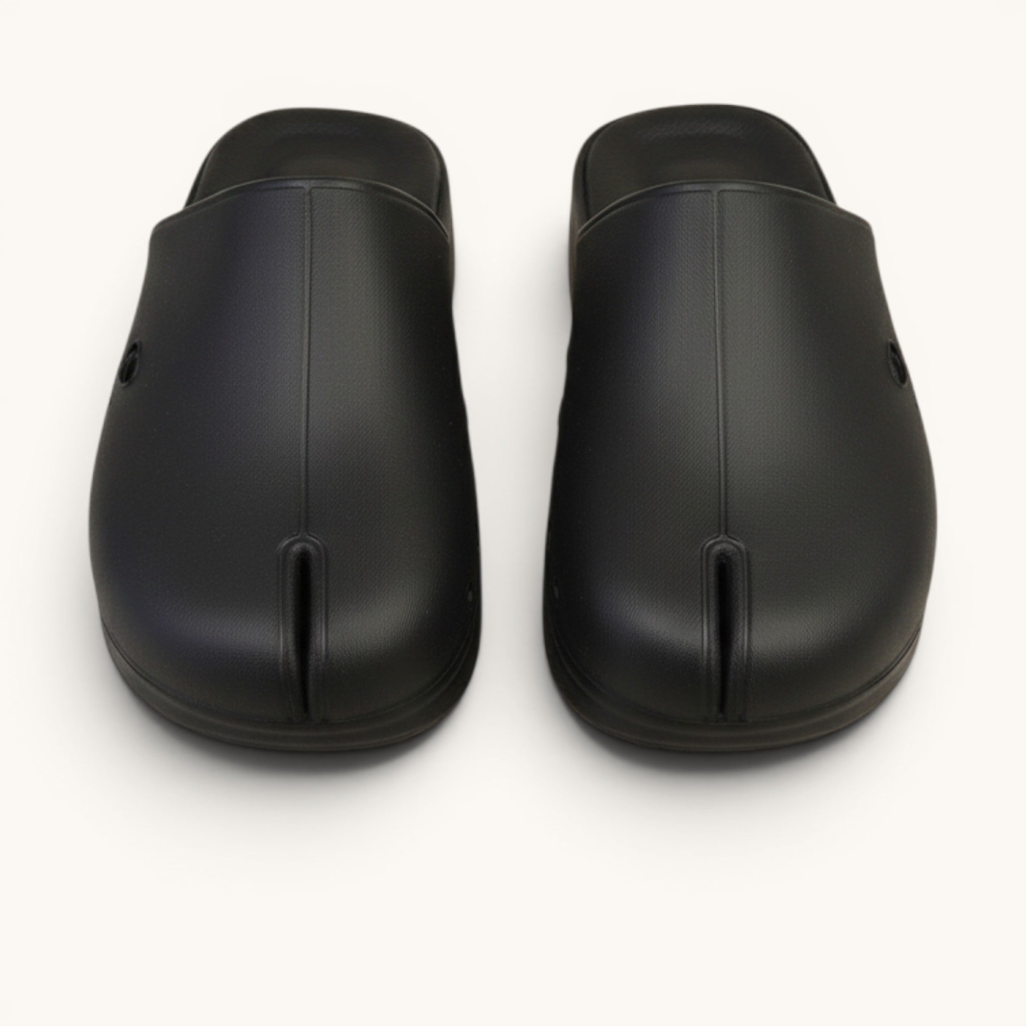 Numero 5 black rubber tabi clogs with a split toe design and cushioned footbed.
