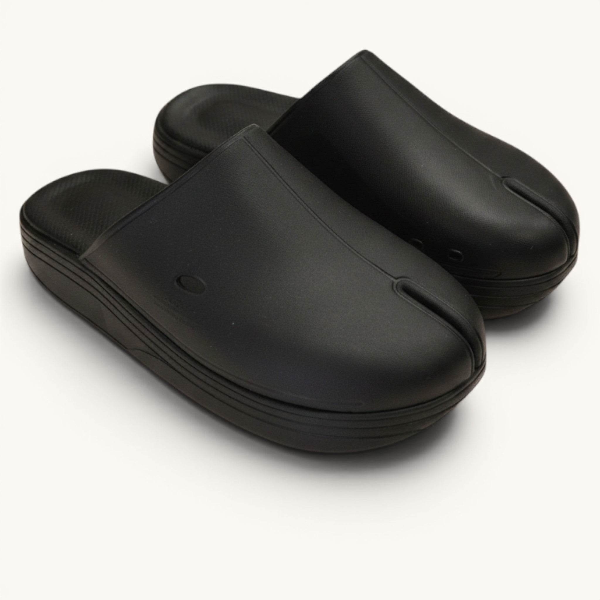 Numero 5 black tabi clogs with white trim and cushioned footbed. Comfortable slip-on style.