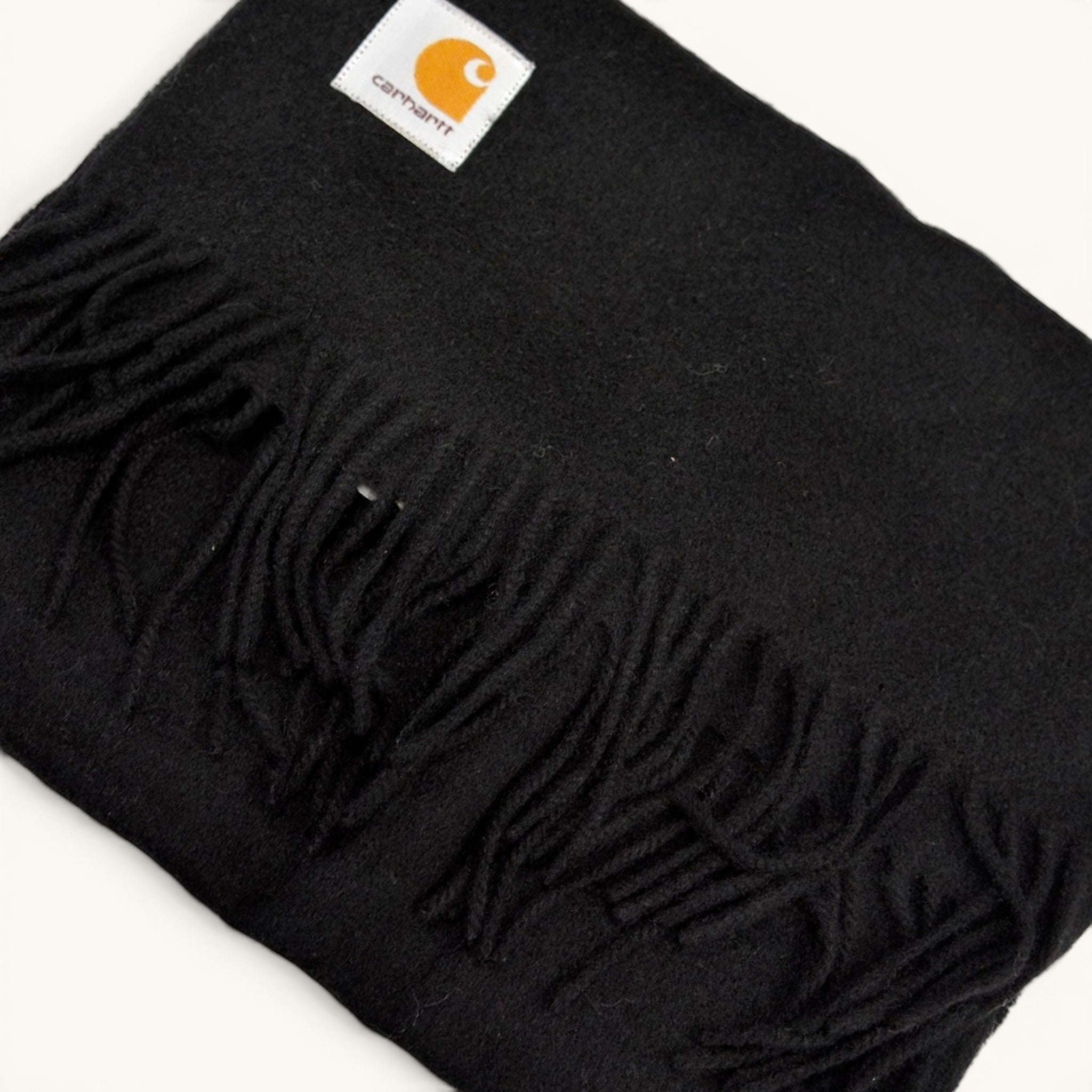 Numero 5 Carhartt WIP black essential scarf with fringe detail and white logo patch. One size fits all.