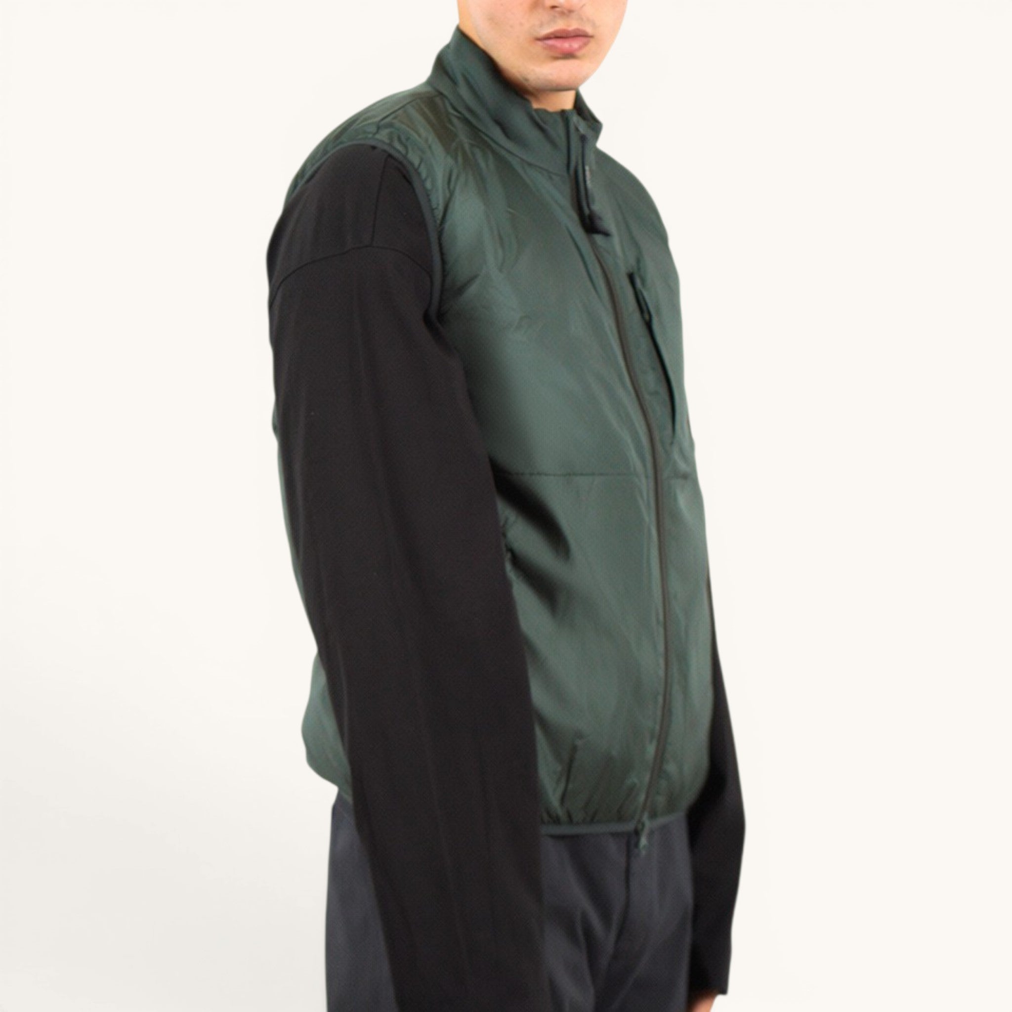 Numero 5 green Aspesi quilted vest with zip closure and chest pocket, worn over a black long-sleeve shirt.