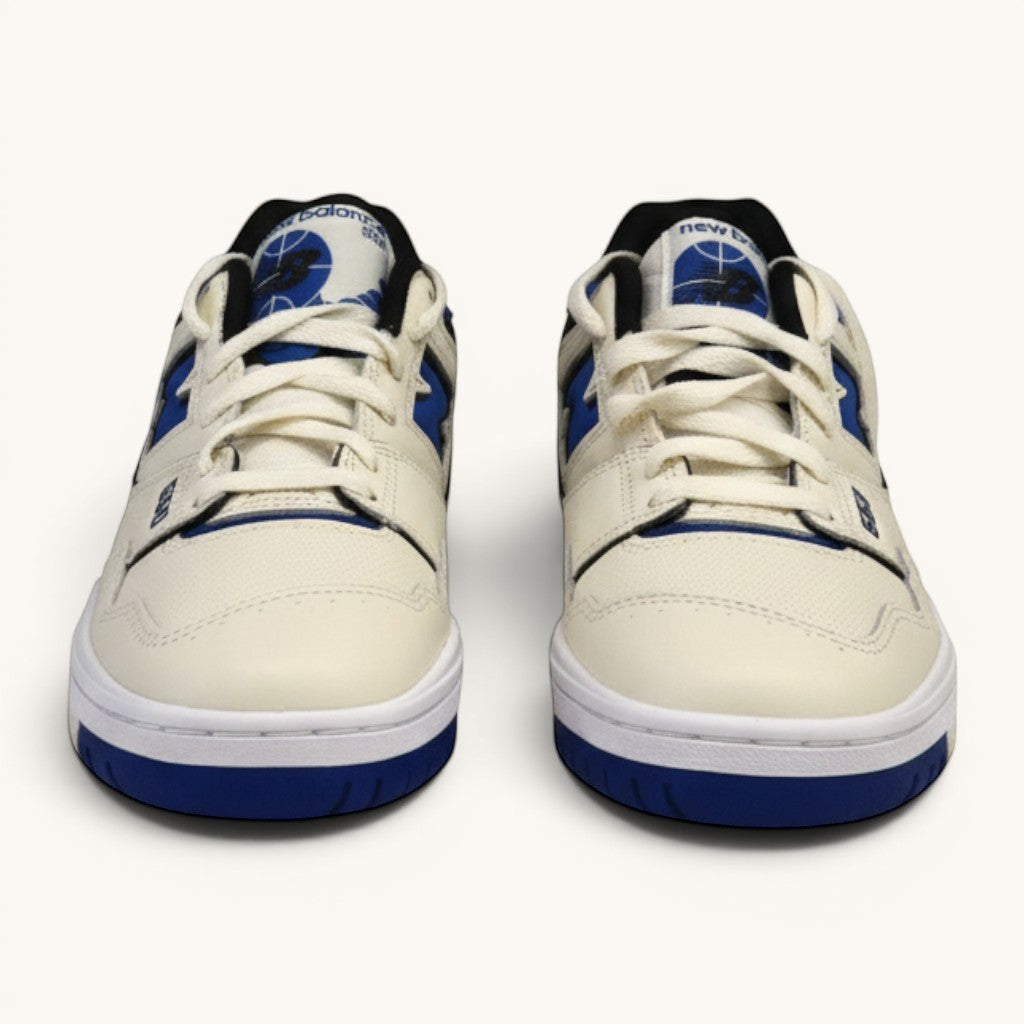 Numero 5 New Balance 550 cream leather sneakers with blue accents and white laces.