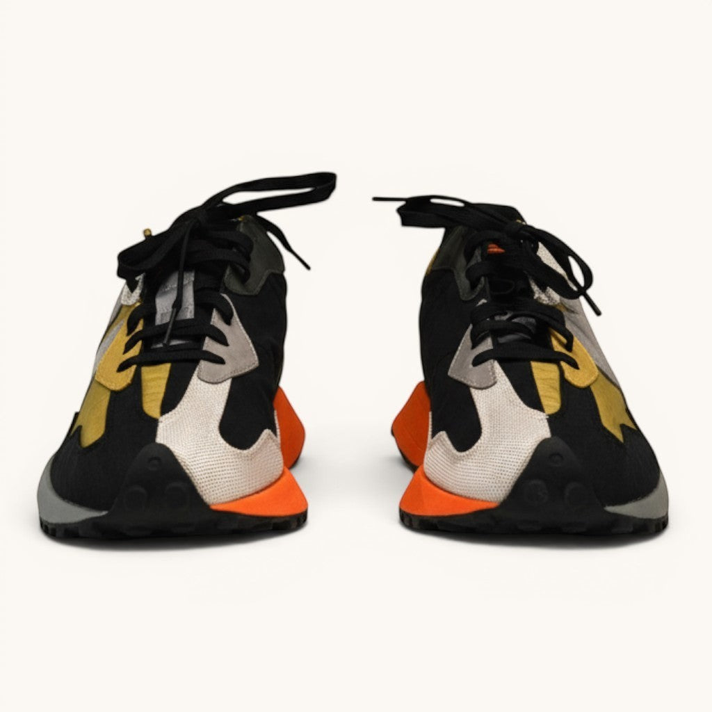 Numero 5 New Balance multicolor sneakers with black, orange, yellow, and grey panels. Lace-up closure.