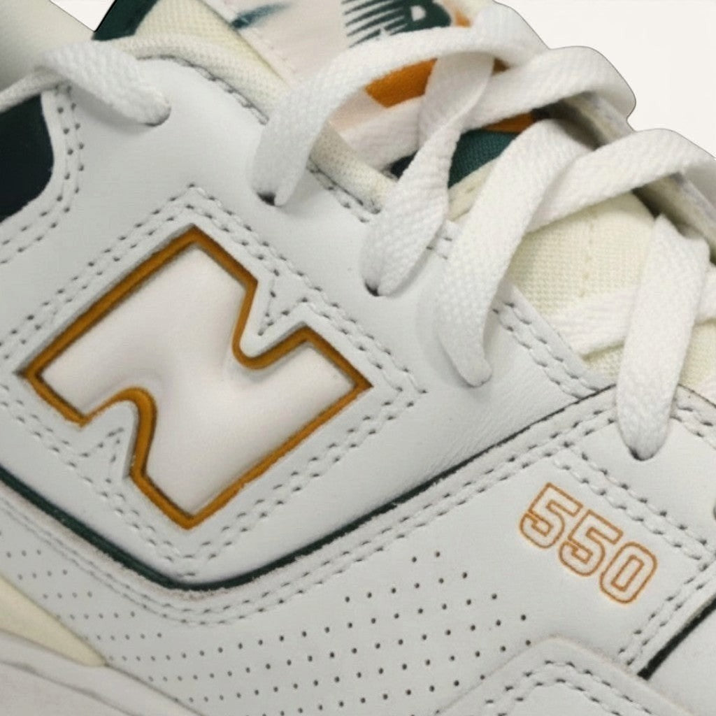 Numero 5 New Balance white leather sneakers with green and orange accents, featuring perforated details and "550" branding.