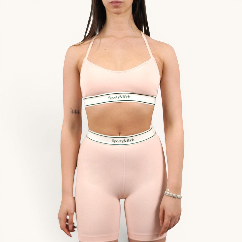 Numero 5 pink nylon and spandex biker shorts with white and green elastic waistband.