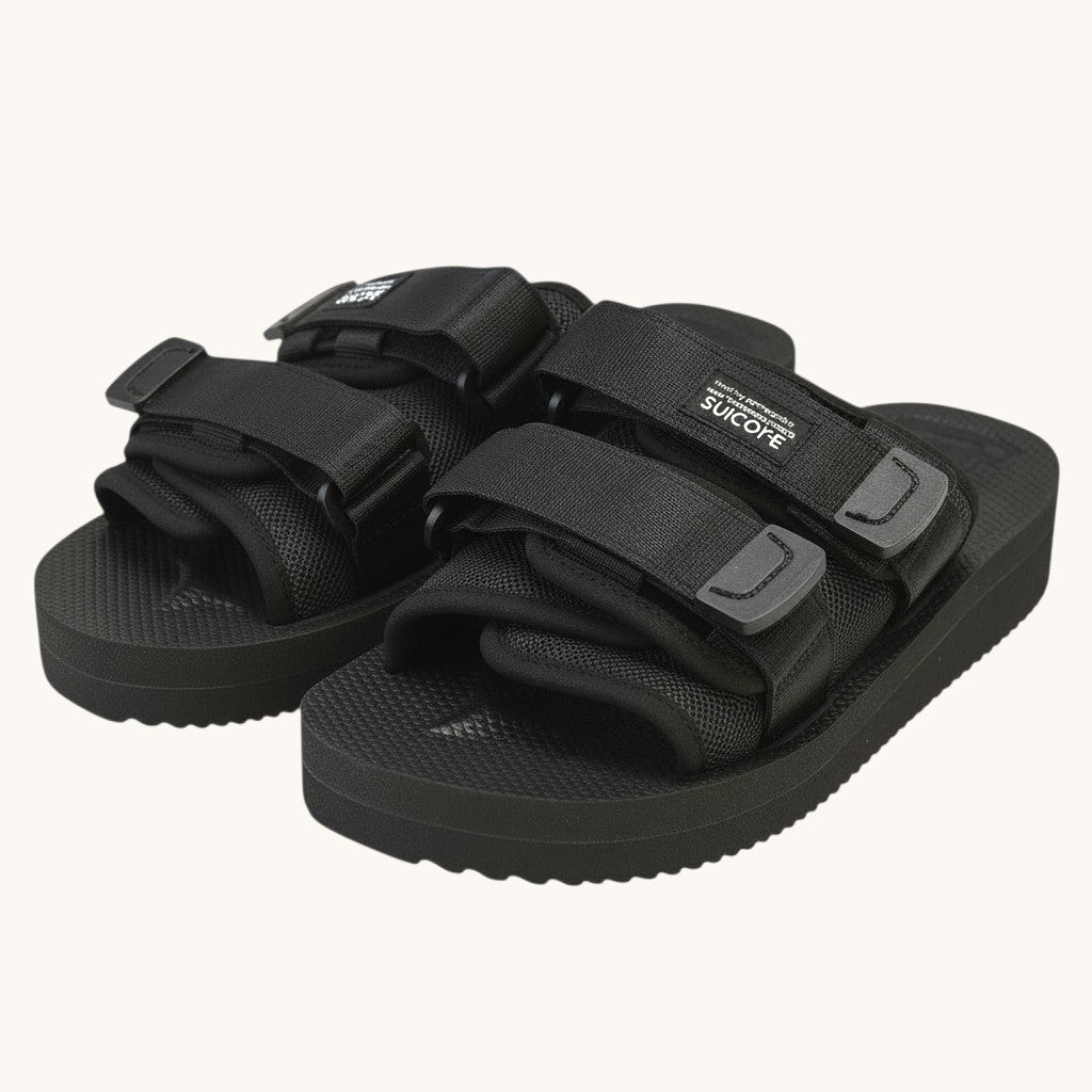 Numero 5 black Suicoke adjustable strap slide sandals with white footbed and textured sole.