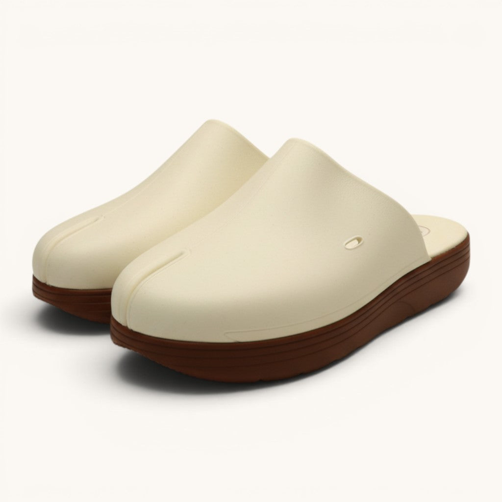 Numero 5 white split-toe clogs with brown soles and ventilation holes.