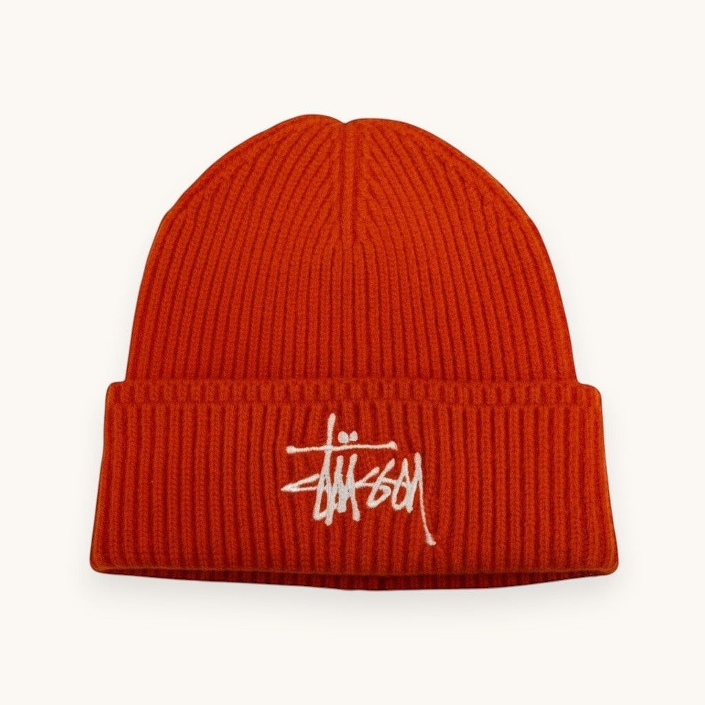 Numero 5 orange ribbed acrylic blend beanie with white Stussy logo embroidery. Streetwear style, one size fits all.